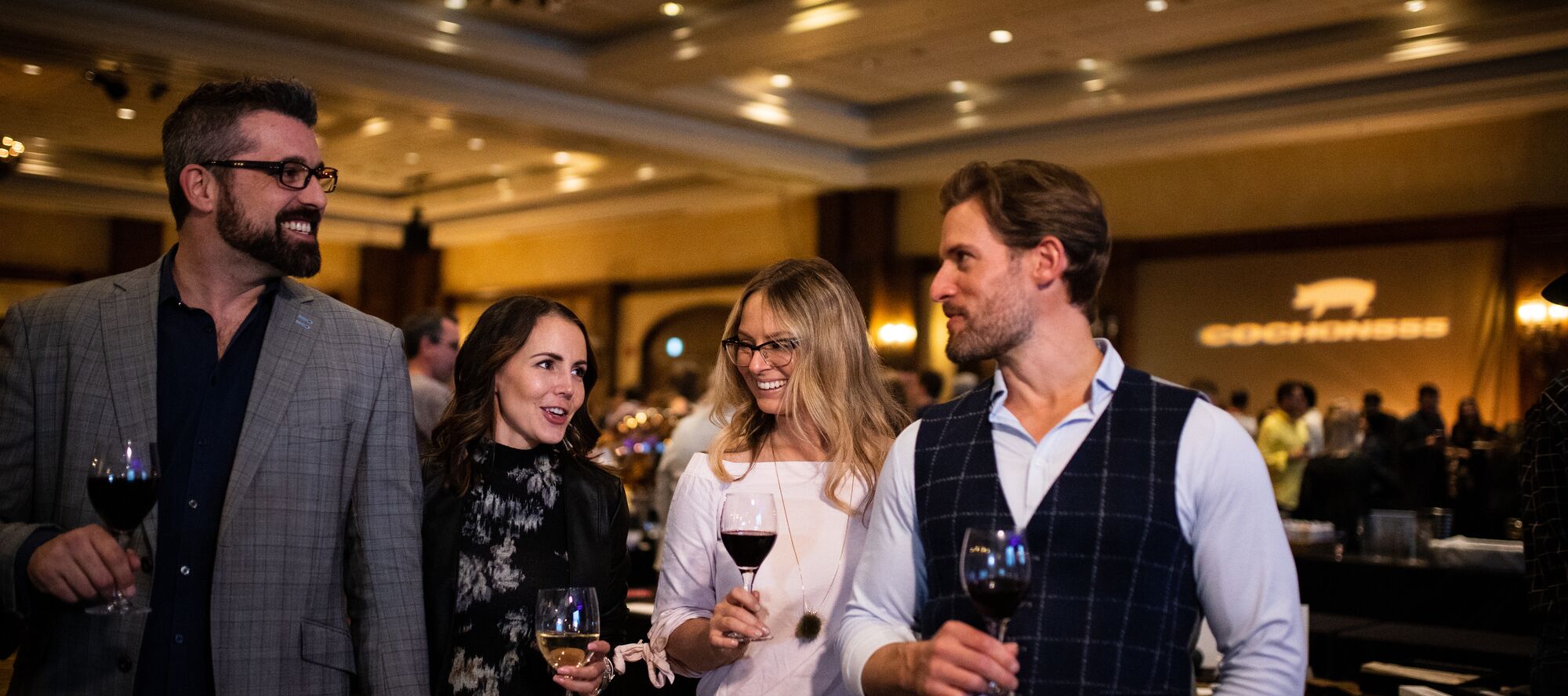 The guests are enjoying a glass of wine while meeting friends at Fairmont Banff Springs.